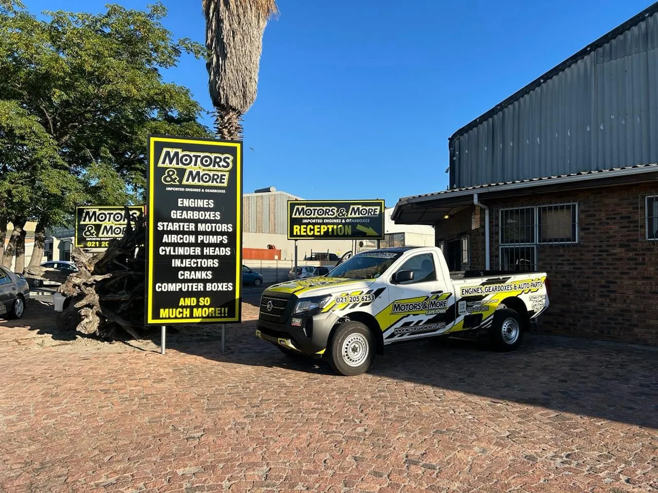 Motors & More Cape Town branded bakkie parked outside with shop signage visible