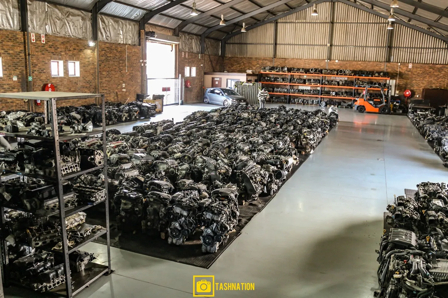 Wide view of the indoor warehouse at Motors & More Cape Town with engines and parts