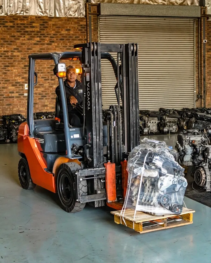Warehouse interior with forklift moving used engines at Motors & More Cape Town