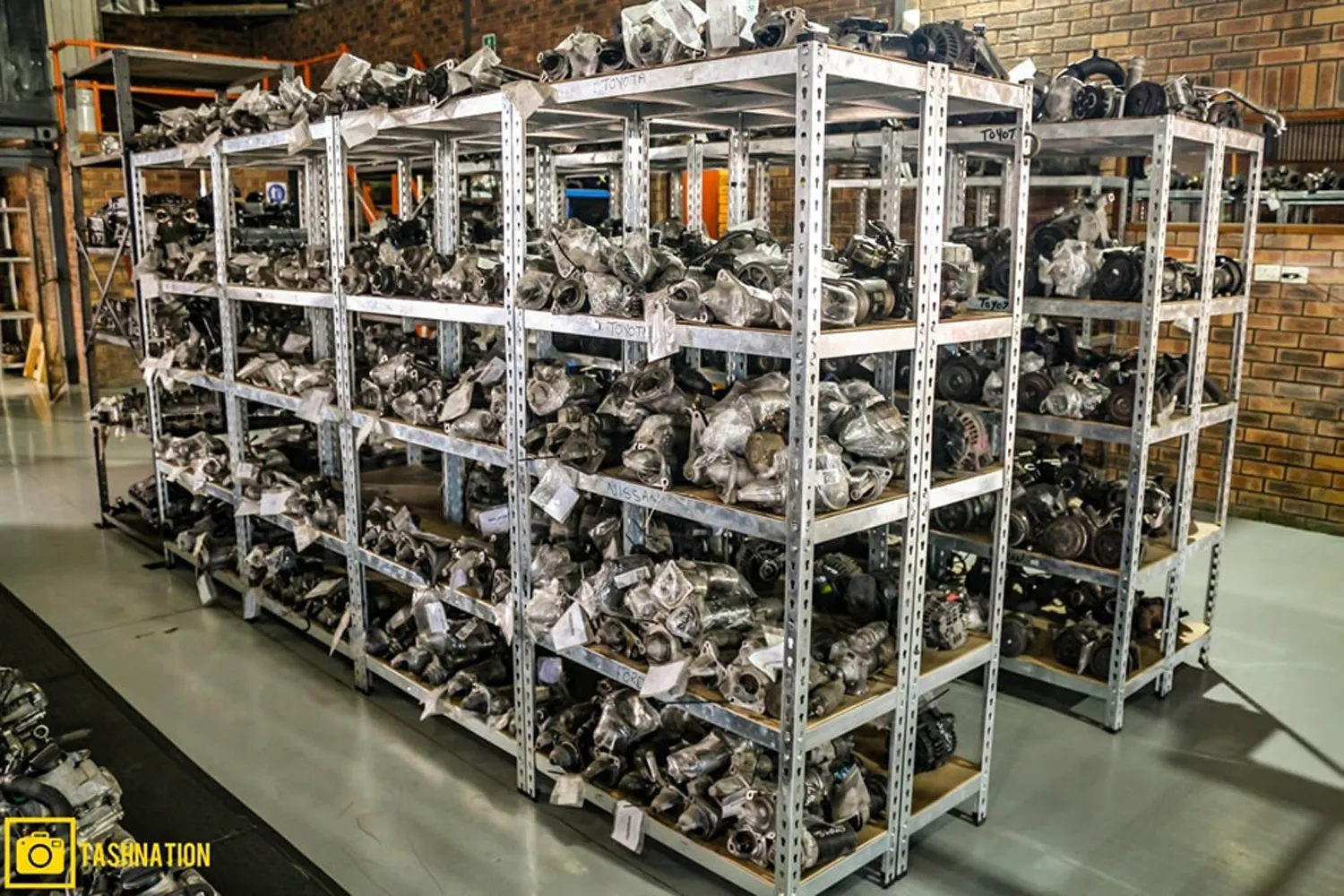 Shelves stocked with used engine parts inside the Cape Town warehouse
