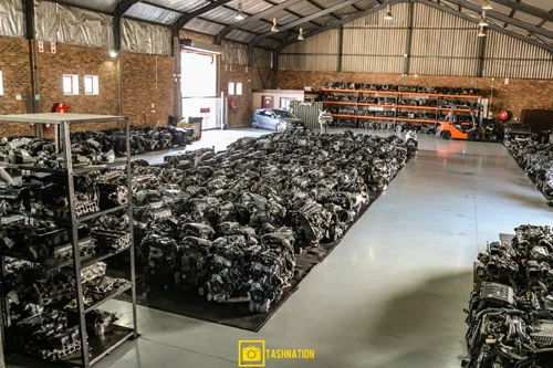 Wide view of the indoor warehouse at Motors & More Cape Town with engines and parts