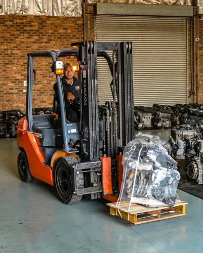 Warehouse interior with forklift moving used engines at Motors & More Cape Town