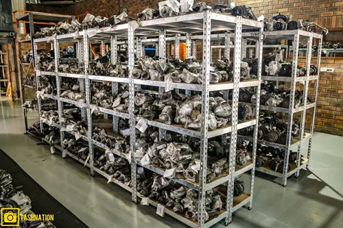 Shelves stocked with used engine parts inside the Cape Town warehouse