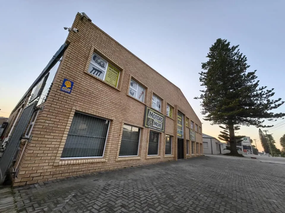 Low wide-angle view of Motors & More Gqeberha building with sky background