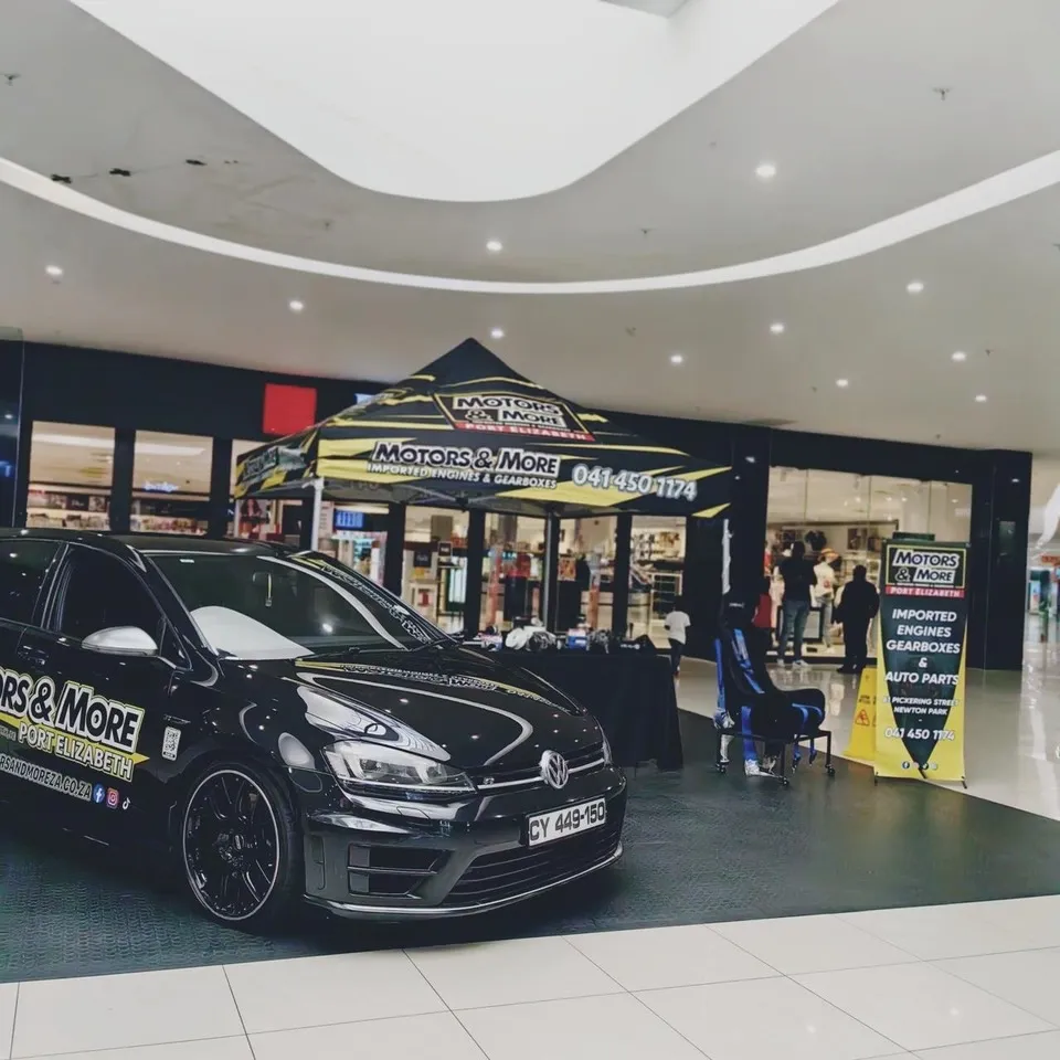 Motors & More Gqeberha showroom with branded tent and show car