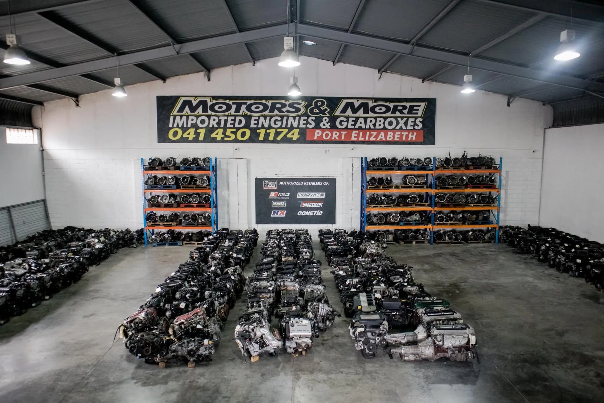 Profile view of used engines lined up in warehouse