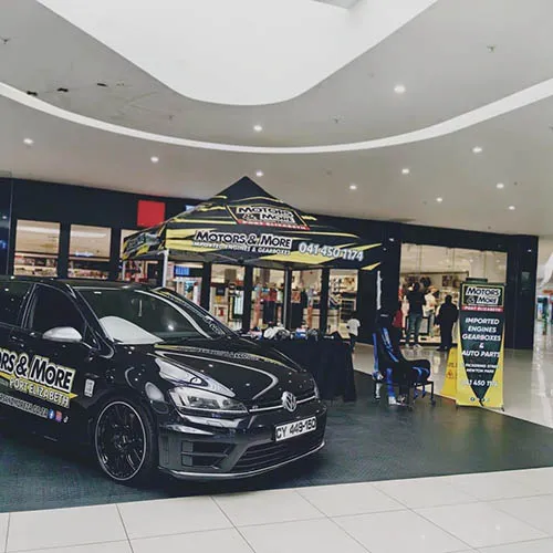 Motors & More Gqeberha showroom with branded tent and show car